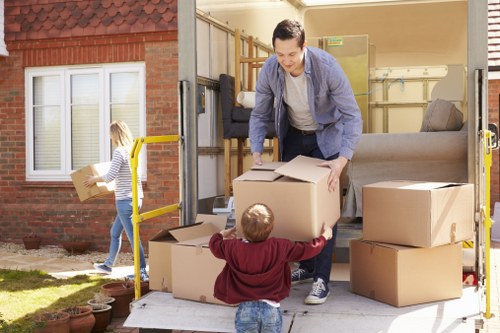 Removal team wearing PPE while carrying furniture safely