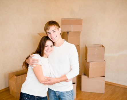 Professional movers handling desks and boxes during an office move
